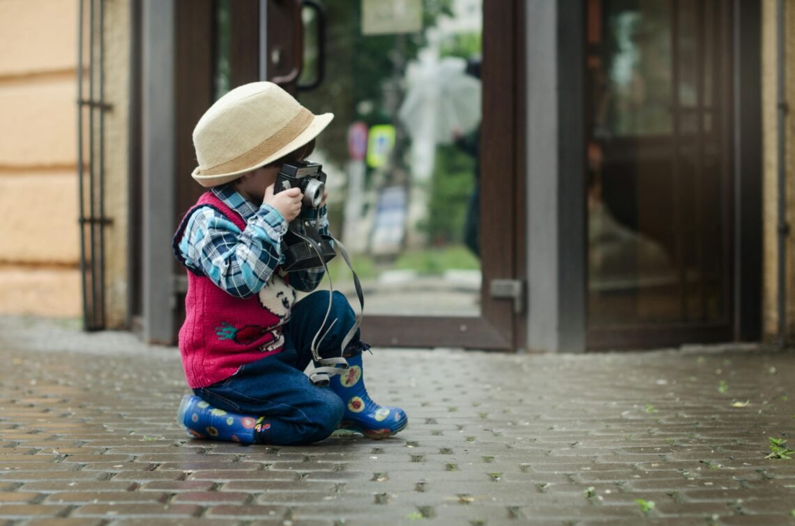 Boy Taking a Photo Using Camera